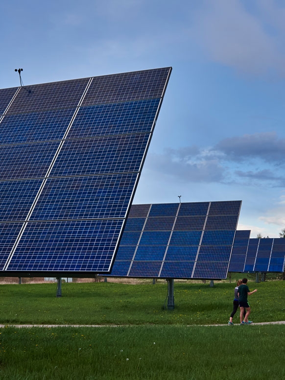 Students run through the solar array near campus.