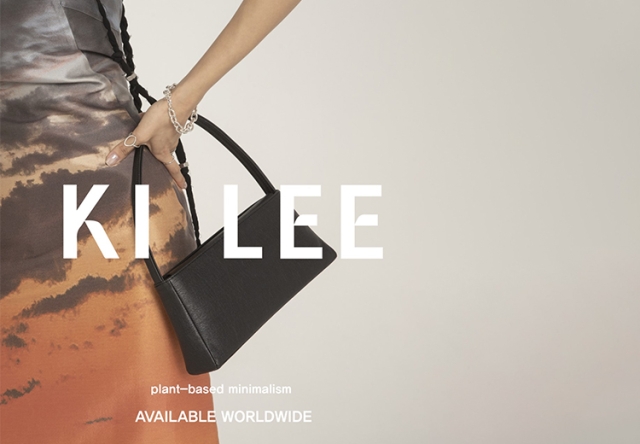 Model holding a black purse with the words "Ki Lee" written across the front