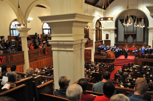 photo of interior chapel with congregation and Christmas decorations