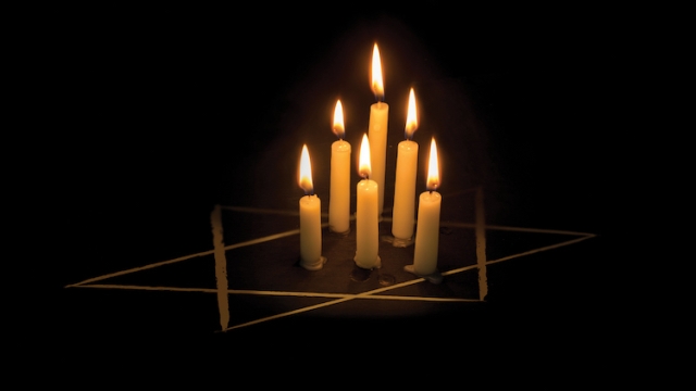 candles of various heights in star of David