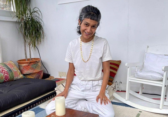 Photo of Himali Singh Soin sitting on the floor of her studio.