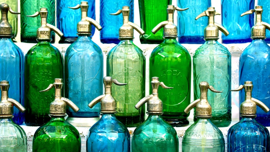 Green, teal, and blue bottles lined up.