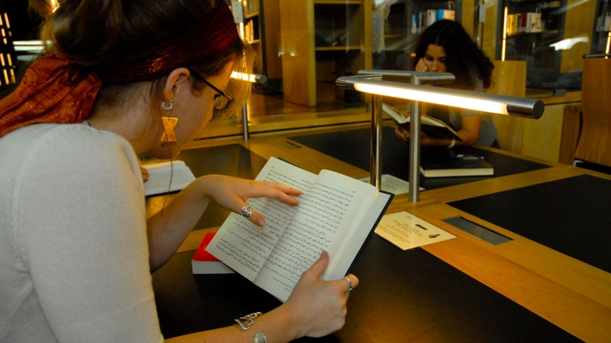 A woman studies in a library.