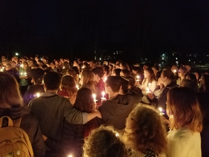 Students at a midnight vigil with candles.