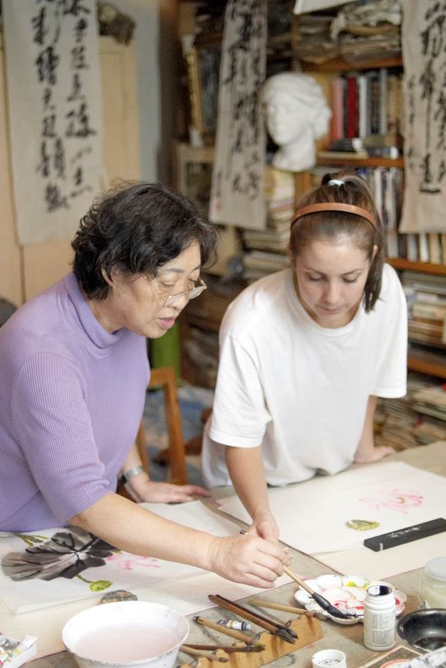 teacher shows student how to do Chinese painting