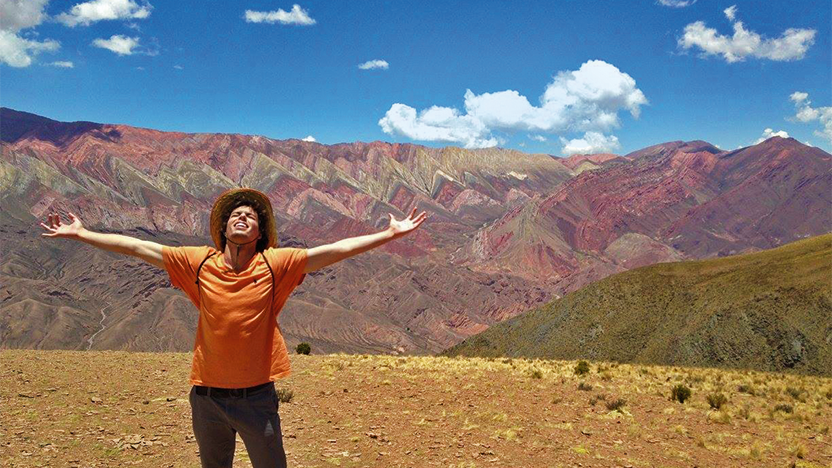David Cremins with arms outstretched and face turned to the sunny Argentinian sky