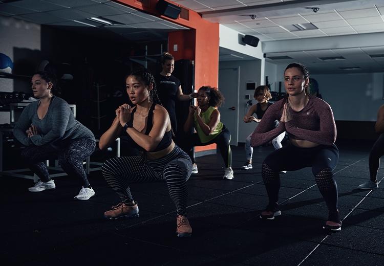 Photo of group workout class in a darkly lit studio