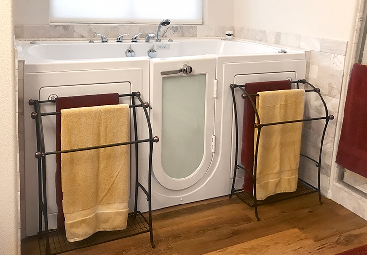 Walk-in bathtub with towel racks in front of it