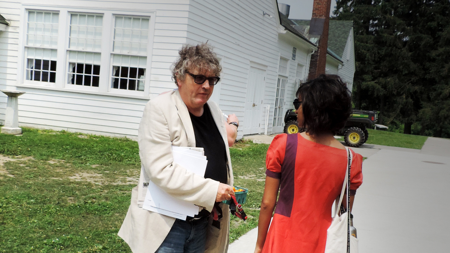 Bread Loaf student chats with a professors as they walk to lunch.
