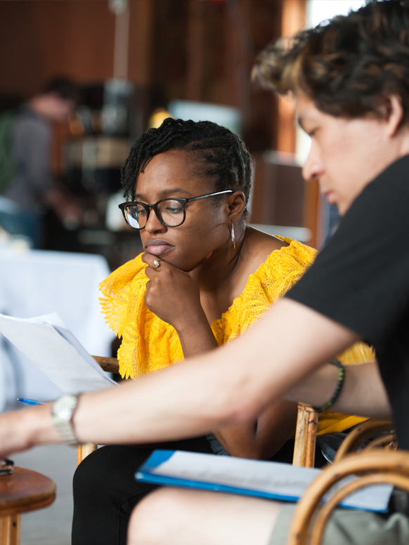 Two Bread Loaf students meet in the Barn to discuss a class project.