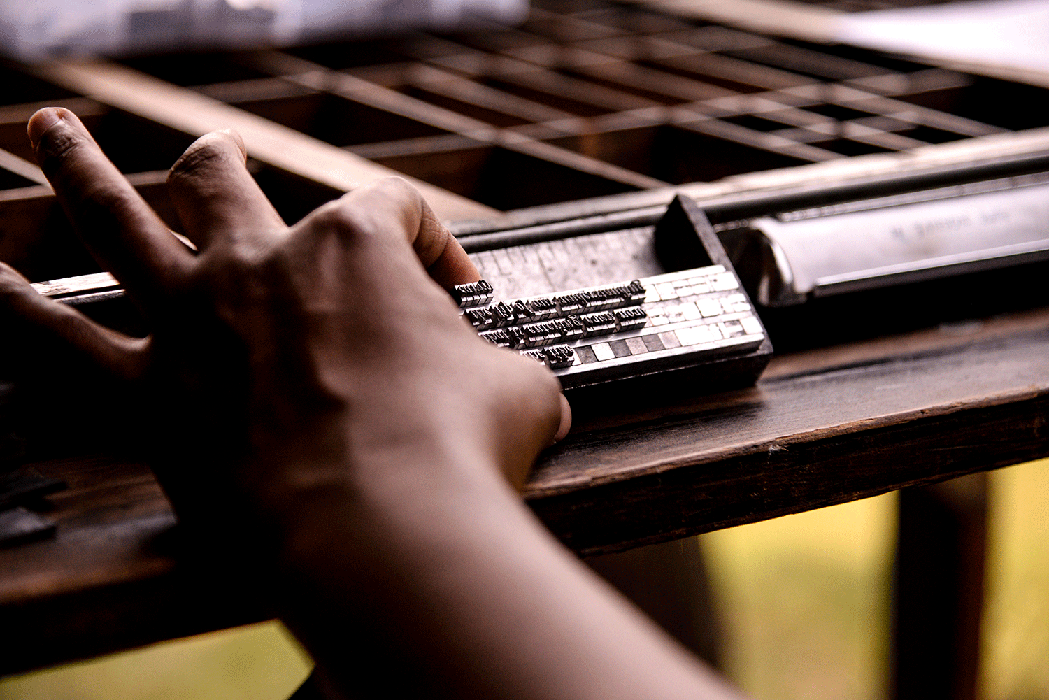 student prepares letterpress type for printing
