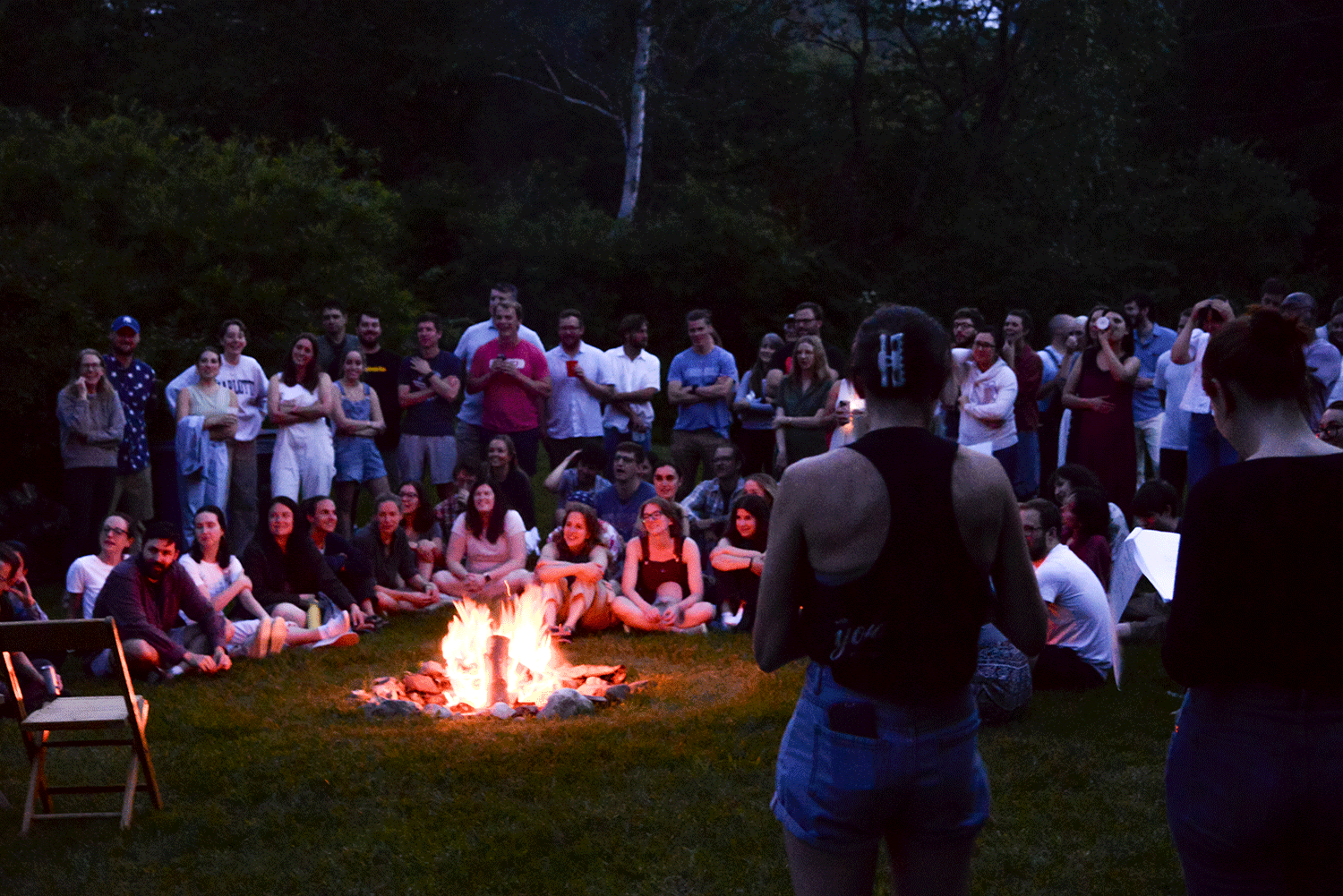 students watch skit at bonfire