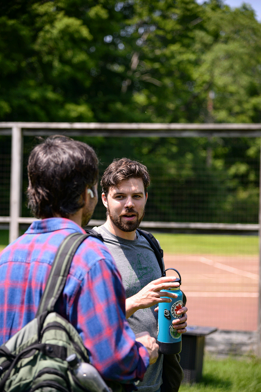 two students talk outside