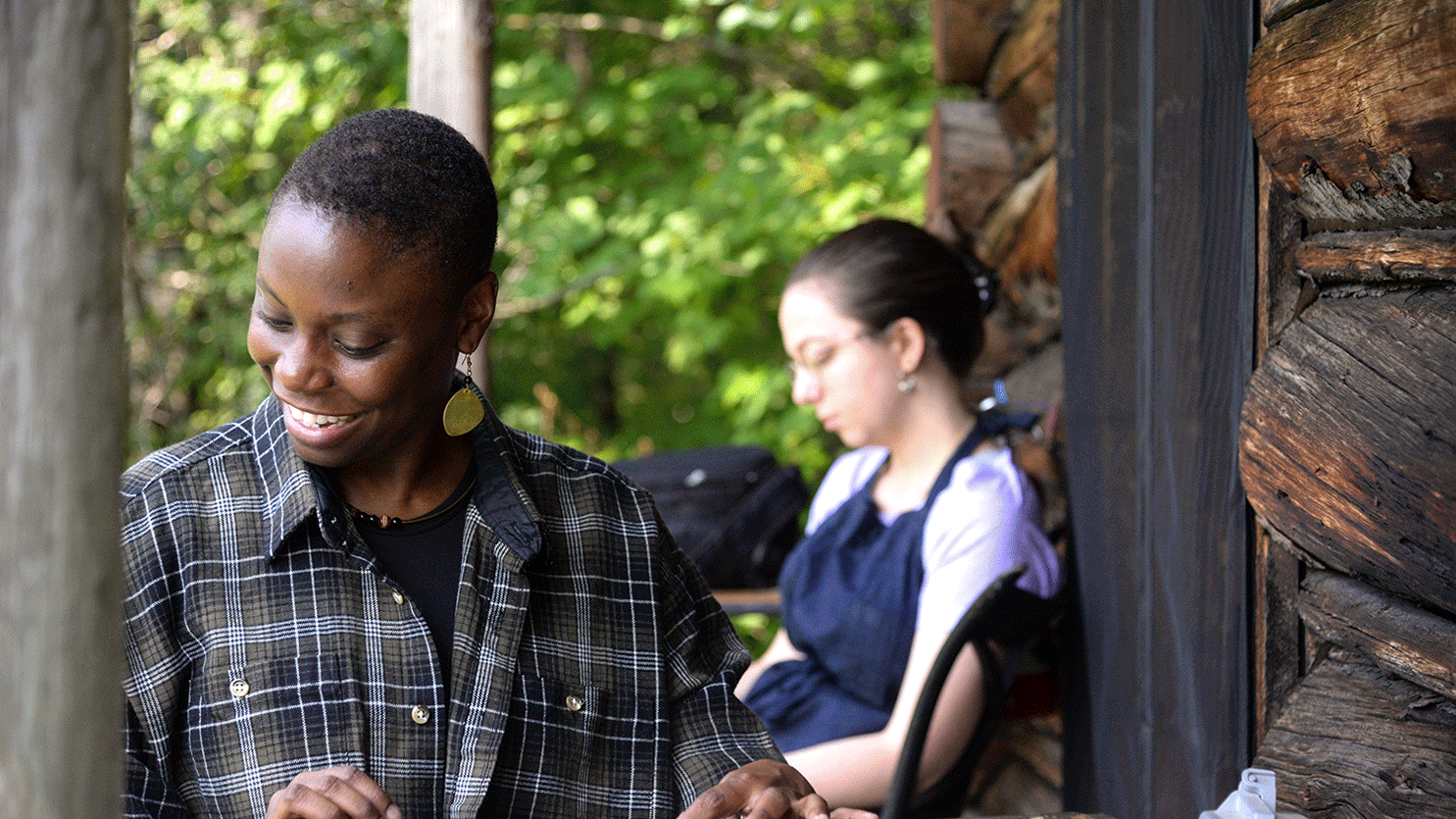 student works outside Bread Loaf printer's cabin