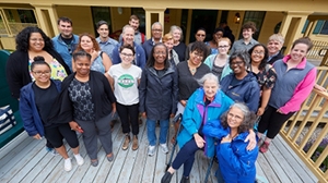 BLSE students gather on campus building porch.