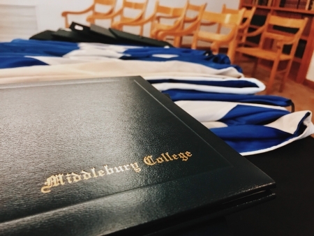 A diploma sits atop a desk.