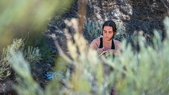 New Mexico Student writes while outdoors.