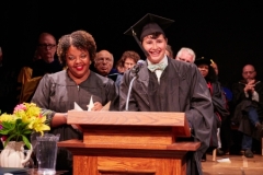 Students at the podium during graduation for the Bread Loaf School of English