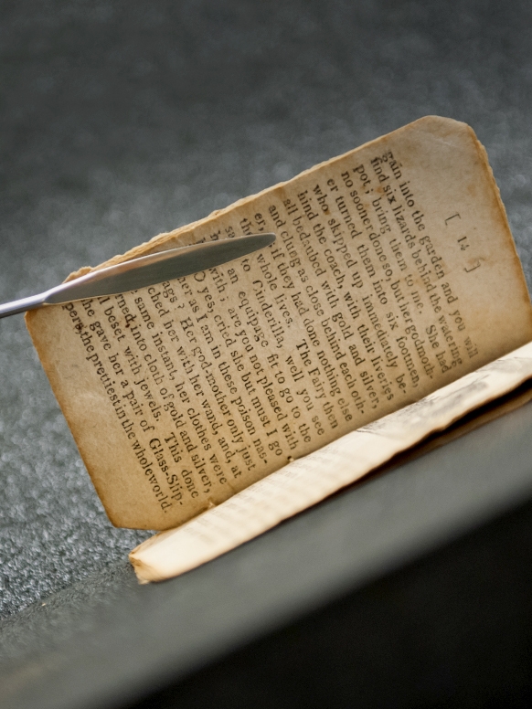 A Bread Loaf student handles an ancient manuscript with care.