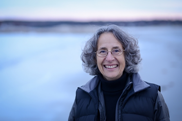 Deborah Cramer standing outside with snow in background.