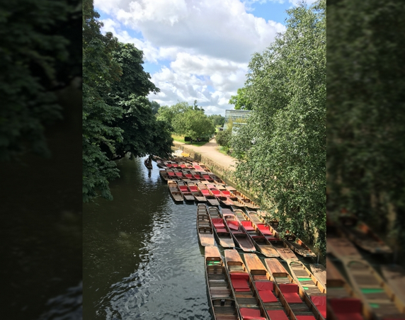 A waterway with several boats parked along the shore.