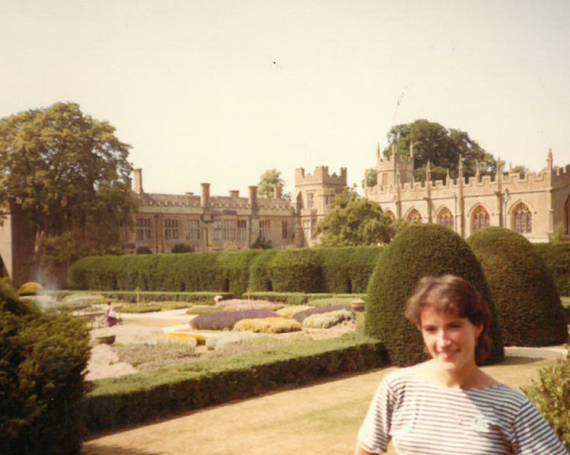 Female student stands outside Oxfords campus many decades ago.