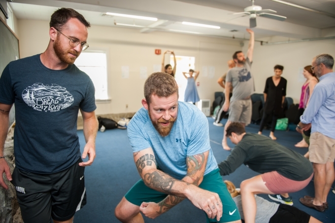 Students in Angela Brazil's Using Theater in the Classroom course in Vermont warm up with movement exercises.