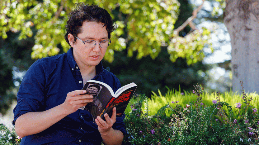 student reading outdoors