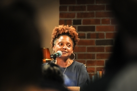 A women with a mic speaks at a BLSE event.