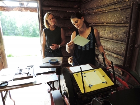 Two female BLSE studnet work with letterpress