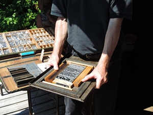 Student placing letters in letterpress at BLSE Ripton campus