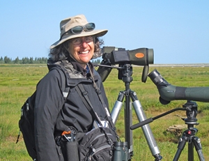Deborah Cramer standing outdoors with camera.