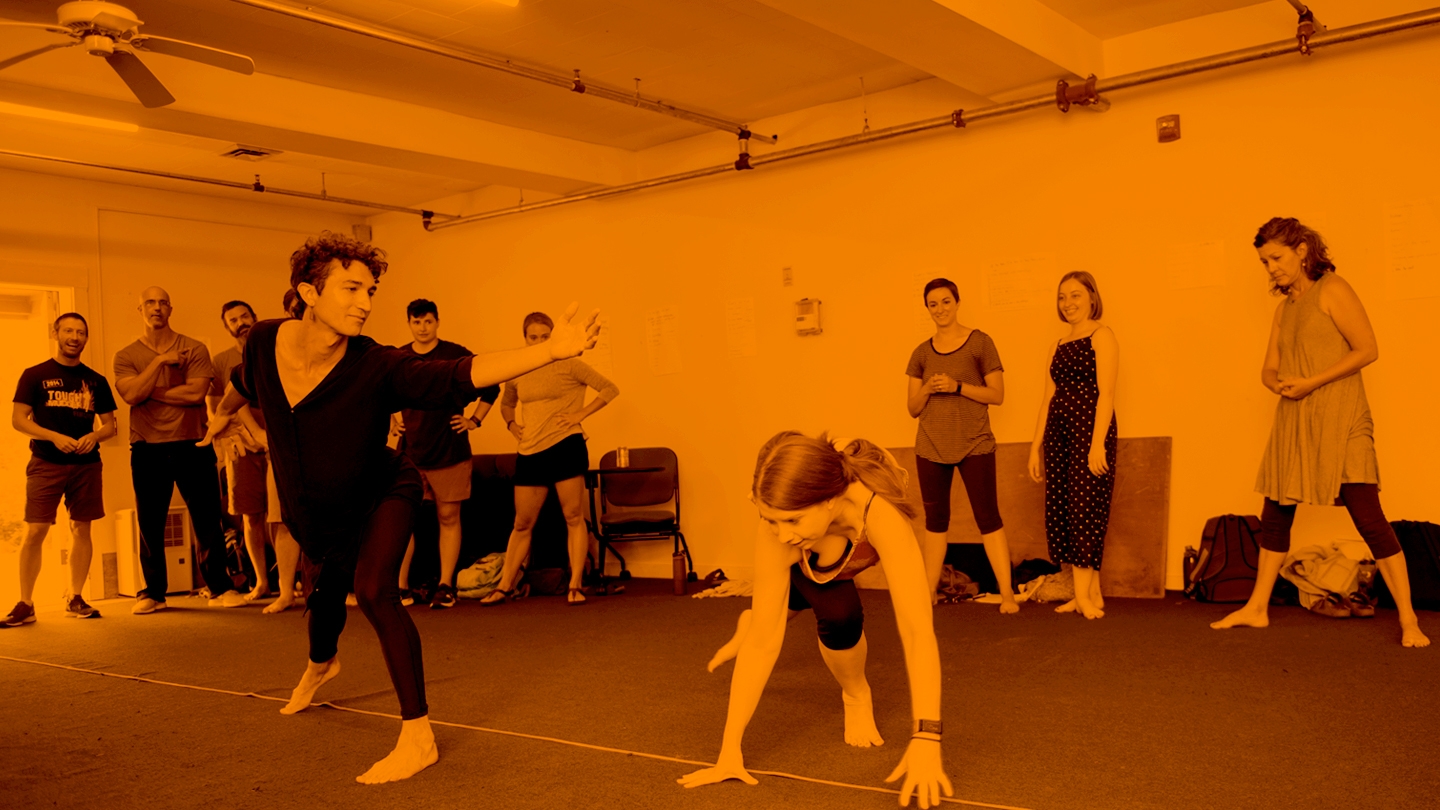 Color Tinted photo of faculty and students participating in the theatre during Bread Loaf School of English