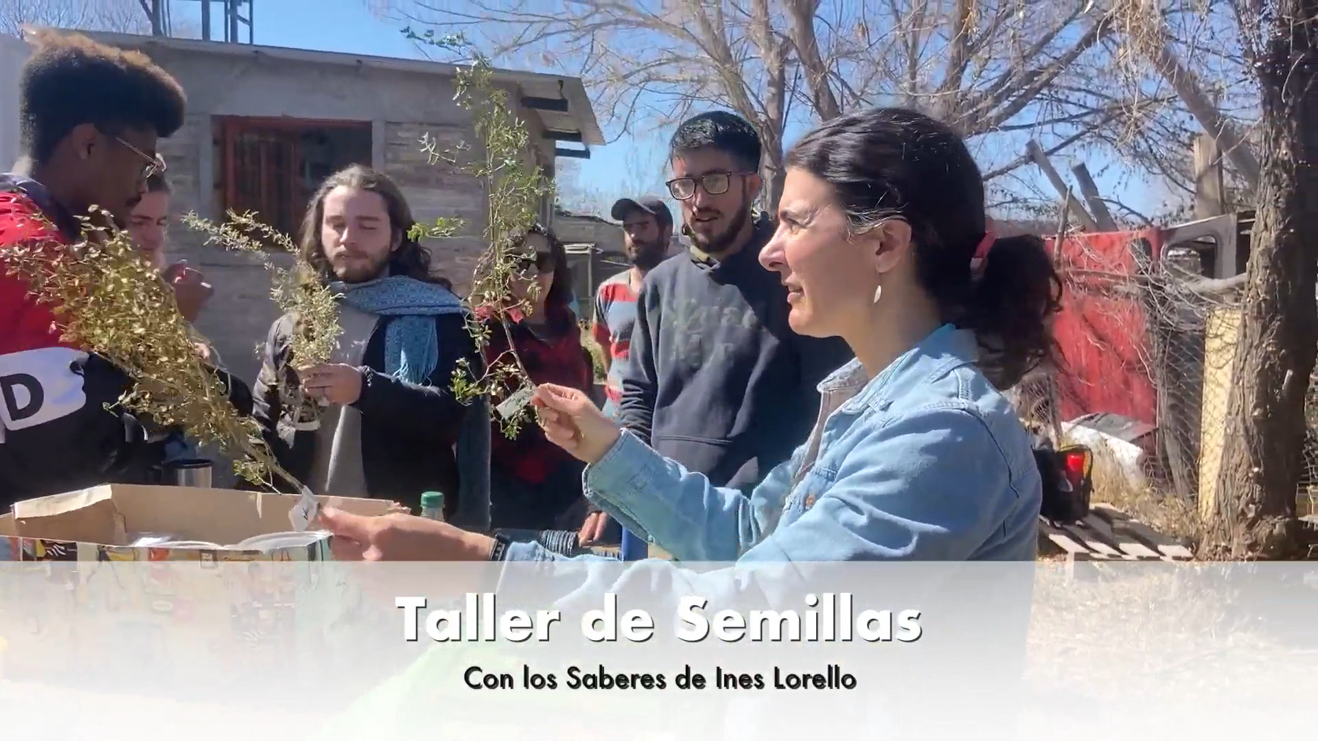 A woman holding plants with students around her, listening