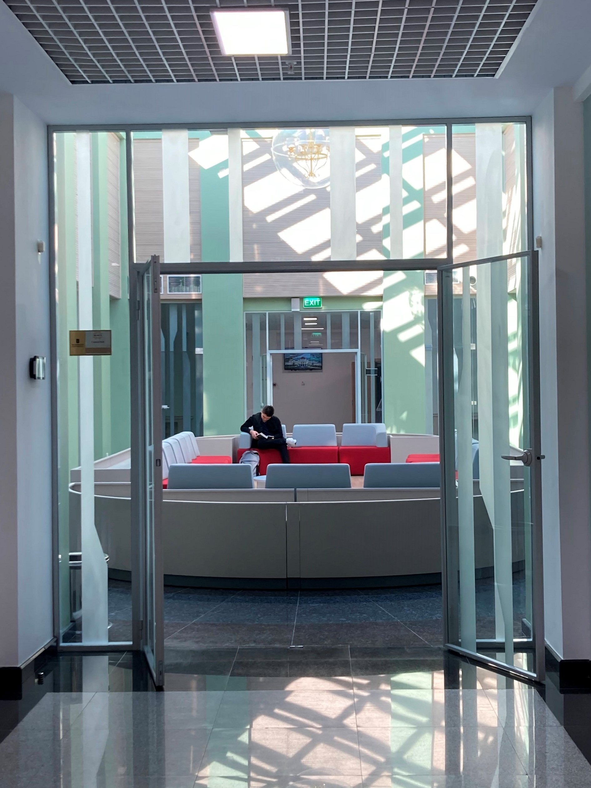 A student reading in a sunny study room