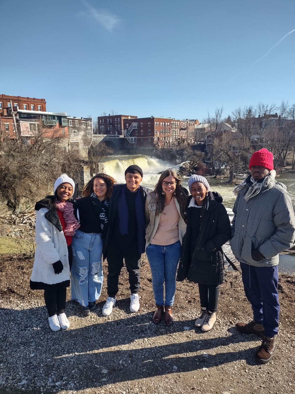 Students in front of a waterfall in Middlebury