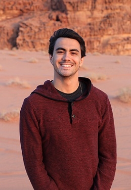 A student smiling in the desert