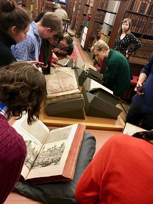students look at massive old books