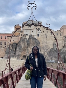 Student smiling on a bridge in Spain