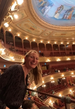 A student smiling in a theater