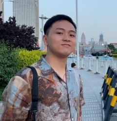 Student smiling on a sidewalk