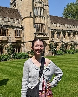 A student in front of a university building in Oxford