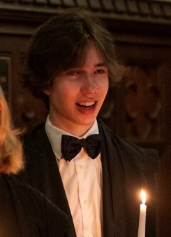 Student singing in the choir in Oxford robes