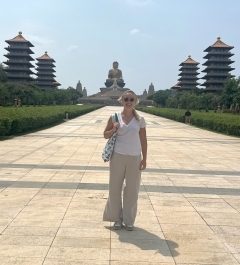 Student smiling in front of a temple