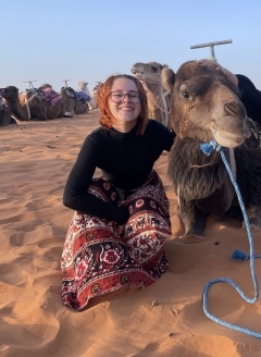 Student smiling with a camel
