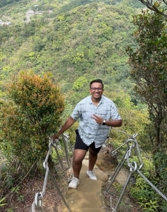 Student smiling as they climb mountain steps