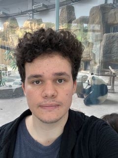 Student taking a selfie in front of a panda
