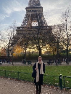 Student in front of the Eiffel Tower at sunset