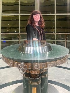 Student smiling in front of a shining statue
