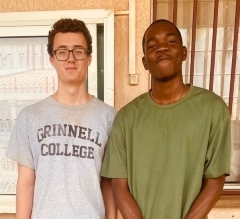Two students smiling, one wearing a grey Grinnell t-shirt